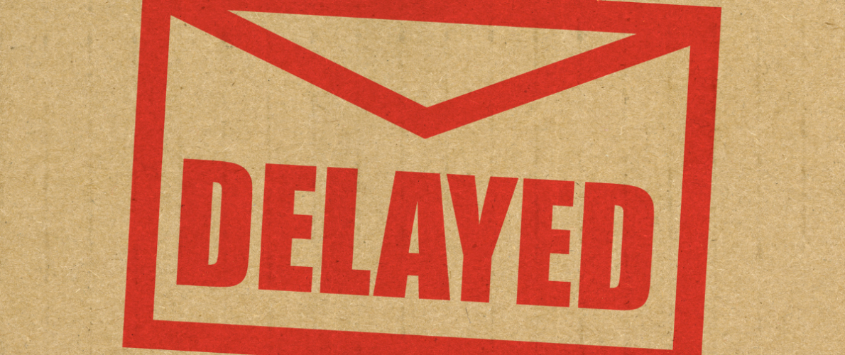 brown paper with a red stamp of an envelope saying delayed